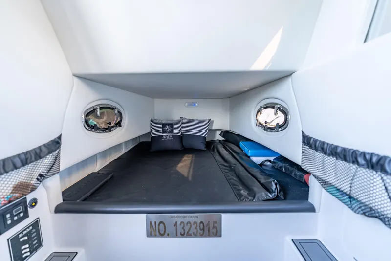 Slide: The Image of 2022 Nor-Tech 390 Sport Center Console cabin interior with bed and portholes. - 47
