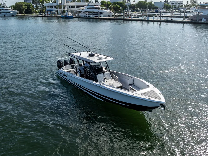 Slide: The Image of 2022 Nor-Tech 390 Sport Center Console boat on water near marina. - 6