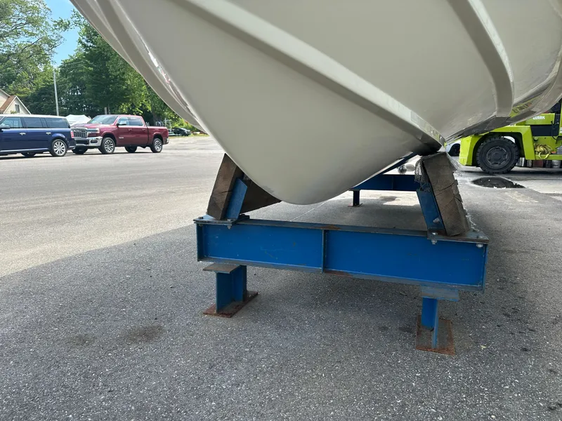 Slide: The Image of 2008 Scout 222 Abaco boat on blue metal stand in parking lot. - 10