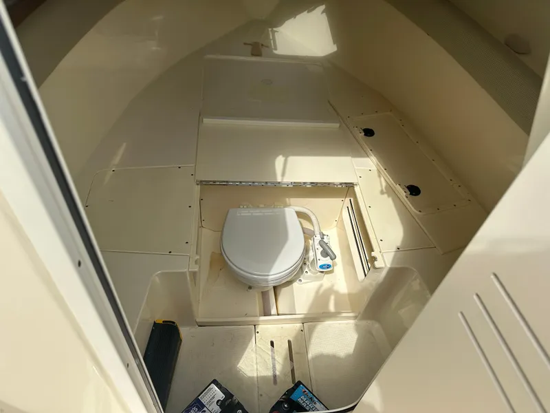 Slide: The Image of 2008 Scout 222 Abaco boat interior with a compact marine toilet. - 13