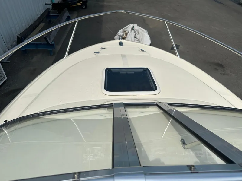 Slide: The Image of 2008 Scout 222 Abaco boat deck with windshield and hatch, docked outdoors. - 14