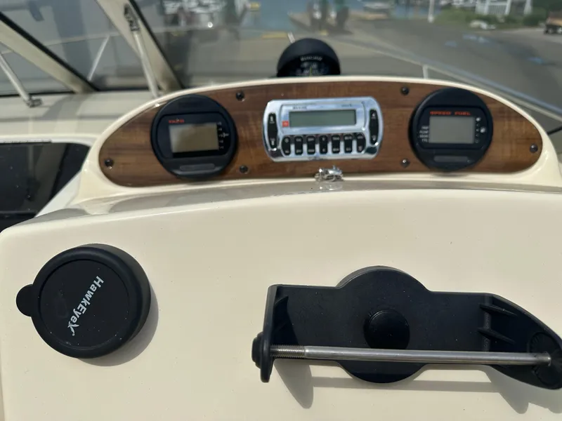 Slide: The Image of Dashboard of a 2008 Scout 222 Abaco boat with gauges and controls. - 15
