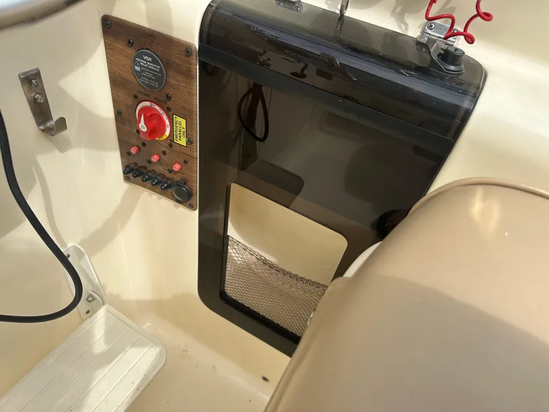 Slide: The Image of Control panel of a 2008 Scout 222 Abaco boat with switches and storage compartment. - 17