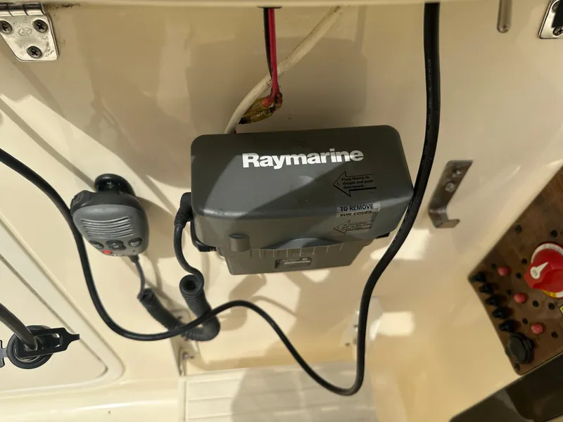 Slide: The Image of Raymarine equipment on 2008 Scout 222 Abaco boat, featuring control panel and wiring. - 18