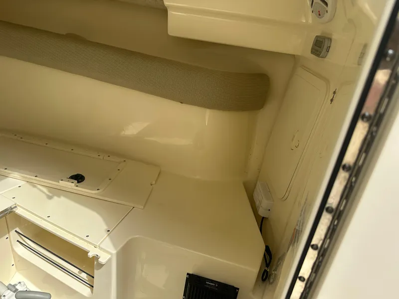 Slide: The Image of 2008 Scout 222 Abaco boat interior, featuring storage compartments and cushioned seating. - 21