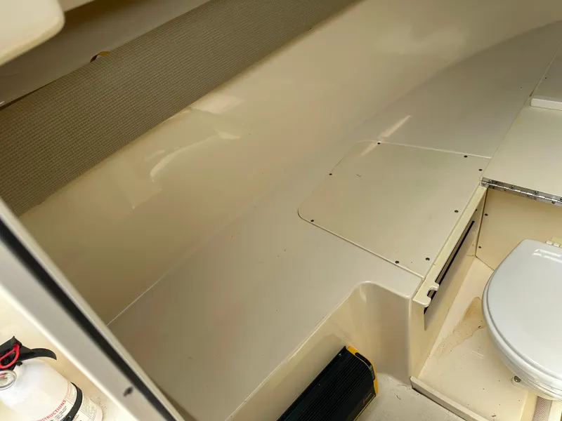 Slide: The Image of 2008 Scout 222 Abaco boat interior with seating and toilet, featuring a fire extinguisher. - 22