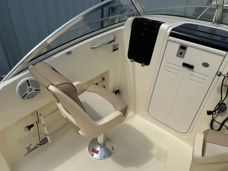 Slide: The Image of 2008 Scout 222 Abaco boat interior with beige seating and control panel. - 4