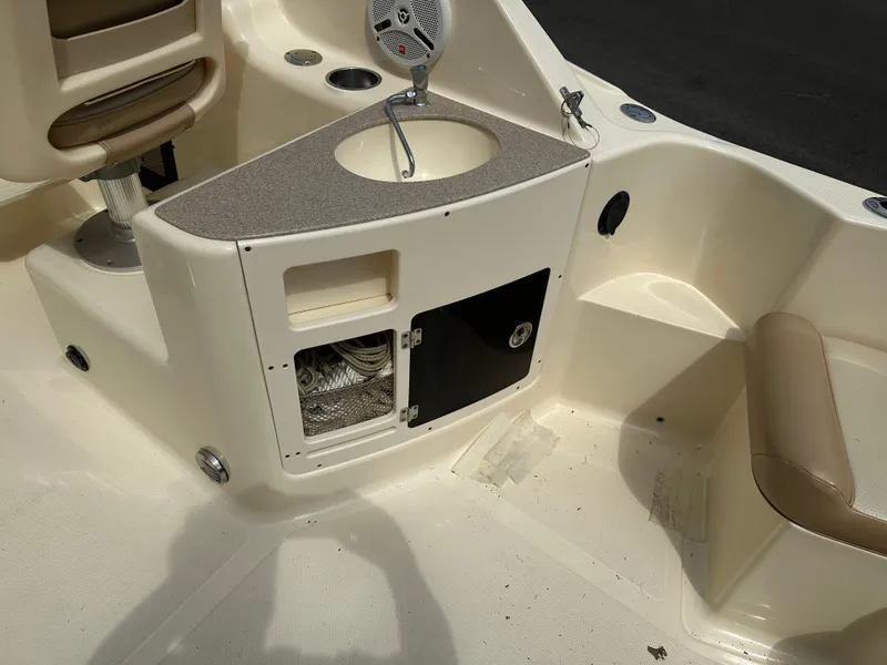 Slide: The Image of 2008 Scout 222 Abaco boat interior with seating, storage, and sink area. - 5