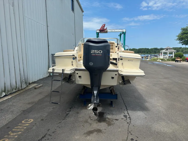 Slide: The Image of 2008 Scout 222 Abaco boat with Yamaha 250 outboard motor, parked near a marina. - 6