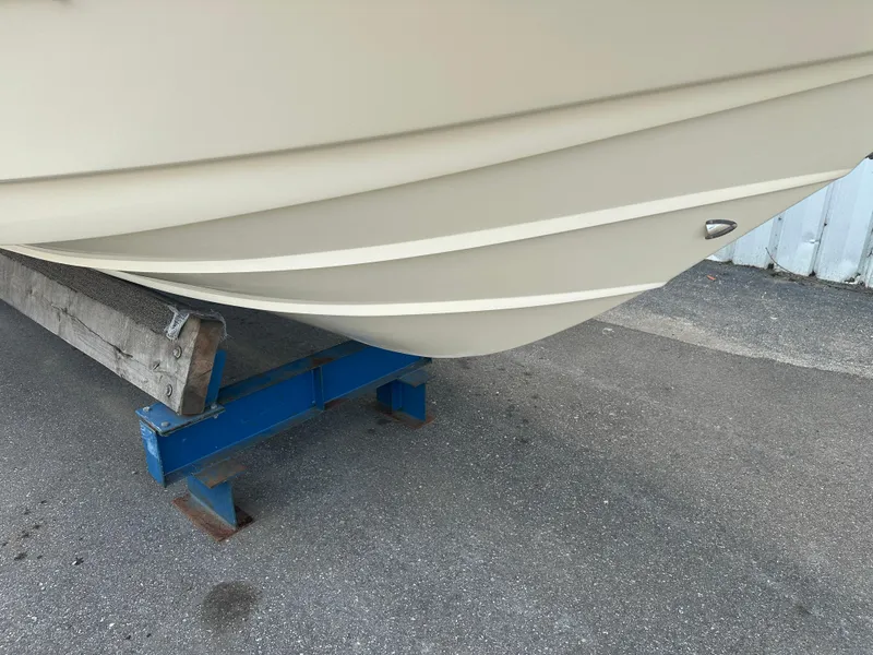 Slide: The Image of 2008 Scout 222 Abaco boat hull on a blue stand, parked on pavement. - 8