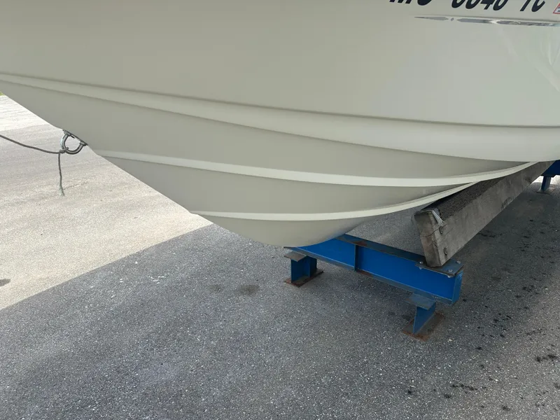 Slide: The Image of 2008 Scout 222 Abaco boat hull on a blue stand, parked on concrete. - 9