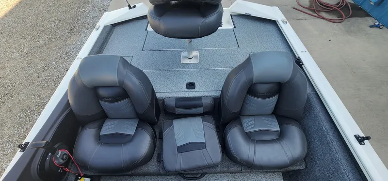 Slide: The Image of 2019 Tracker Pro Team 190 TX Tournament Edition boat interior with three gray seats. - 10