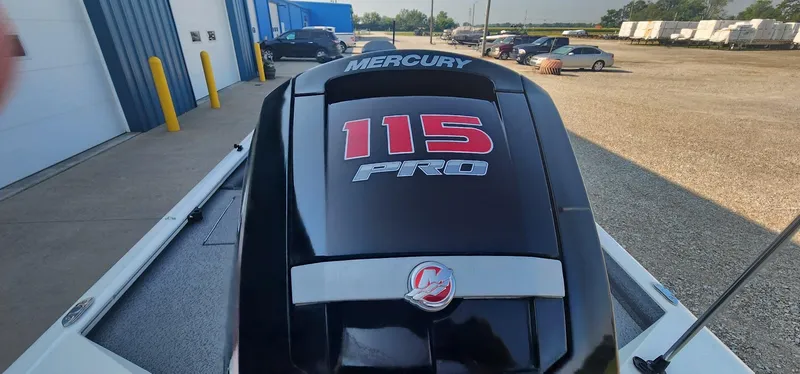 Slide: The Image of 2019 Tracker Pro Team 190 TX Tournament Edition with Mercury 115 Pro engine in a parking lot. - 14