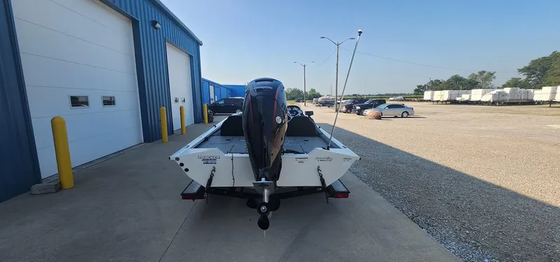 Slide: The Image of 2019 Tracker Pro Team 190 TX Tournament Edition boat parked outside a blue warehouse. - 3