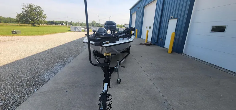 Slide: The Image of 2019 Tracker Pro Team 190 TX Tournament Edition boat parked outside blue building. - 4