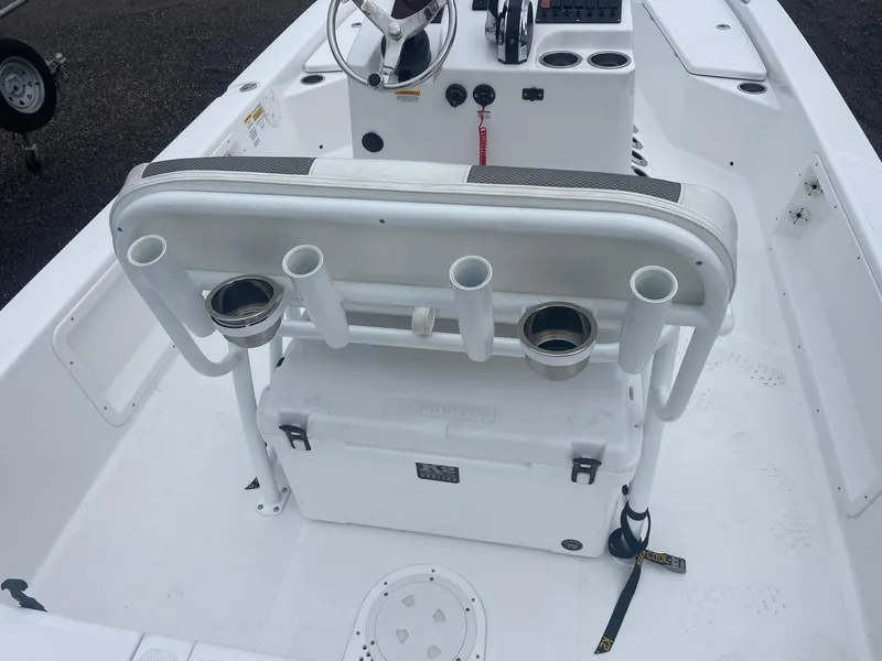 Slide: The Image of 2023 Frontier 2104 boat interior with rod holders and cooler. - 11