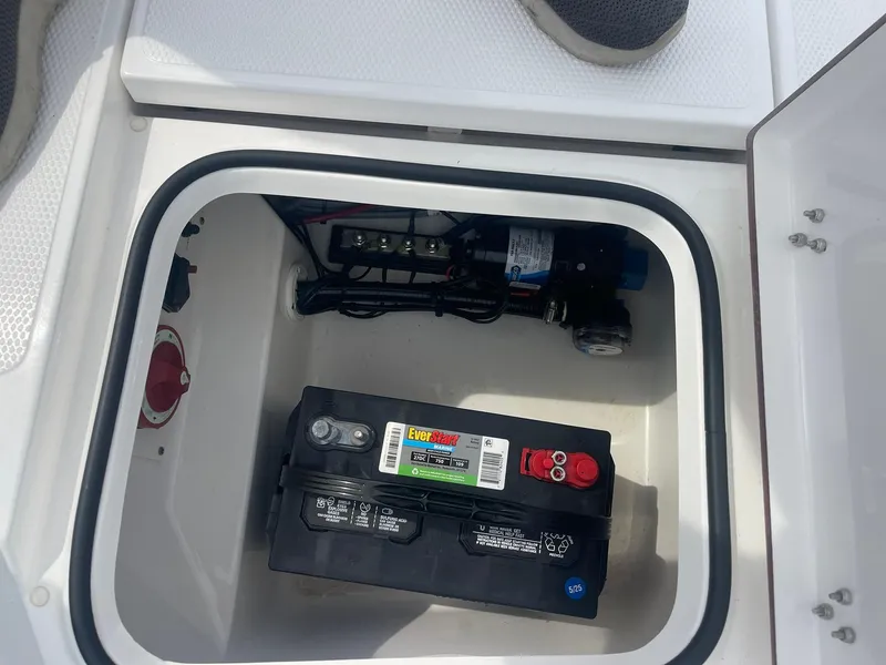 Slide: The Image of Battery compartment of 2023 Frontier 2104 boat with EverStart battery. - 16