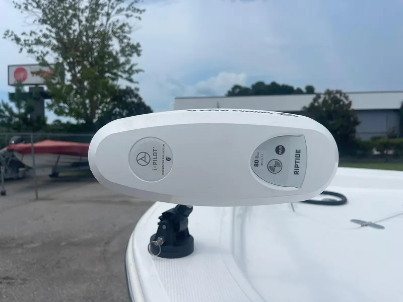 Slide: The Image of 2023 Frontier 2104 boat with i-Pilot Riptide trolling motor, outdoor setting. - 7