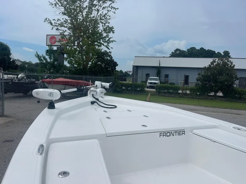 Slide: The Image of 2023 Frontier 2104 boat docked outdoors near industrial building. - 9