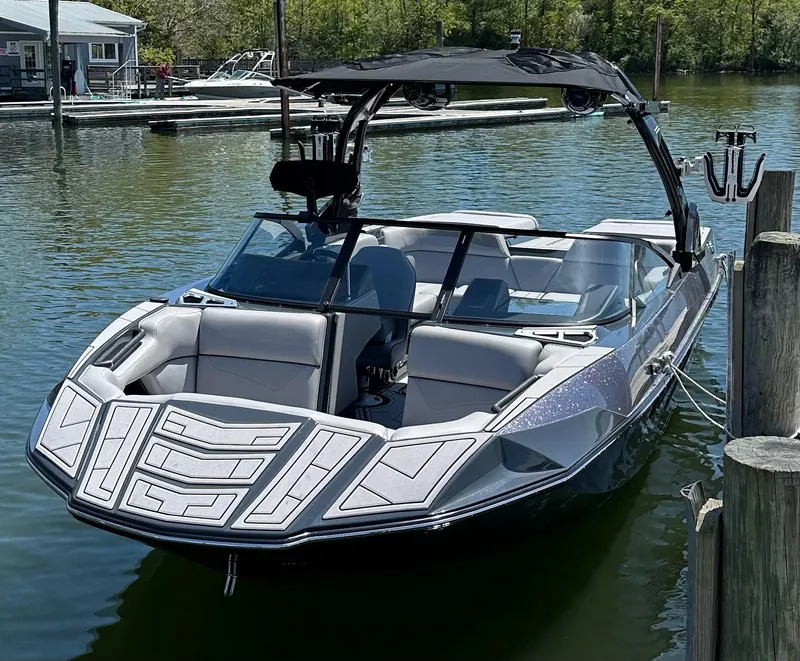 Slide: The Image of 2024 Moomba Kaiyen boat docked on calm water, featuring sleek design and modern amenities. - 3