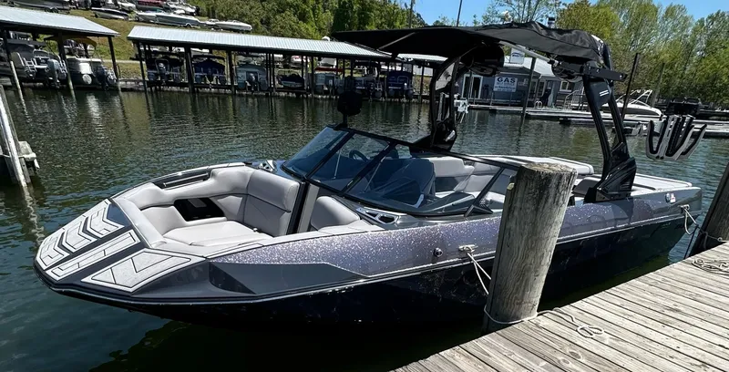 Slide: The Image of 2024 Moomba Kaiyen boat docked at a marina, featuring sleek design and modern amenities. - 4