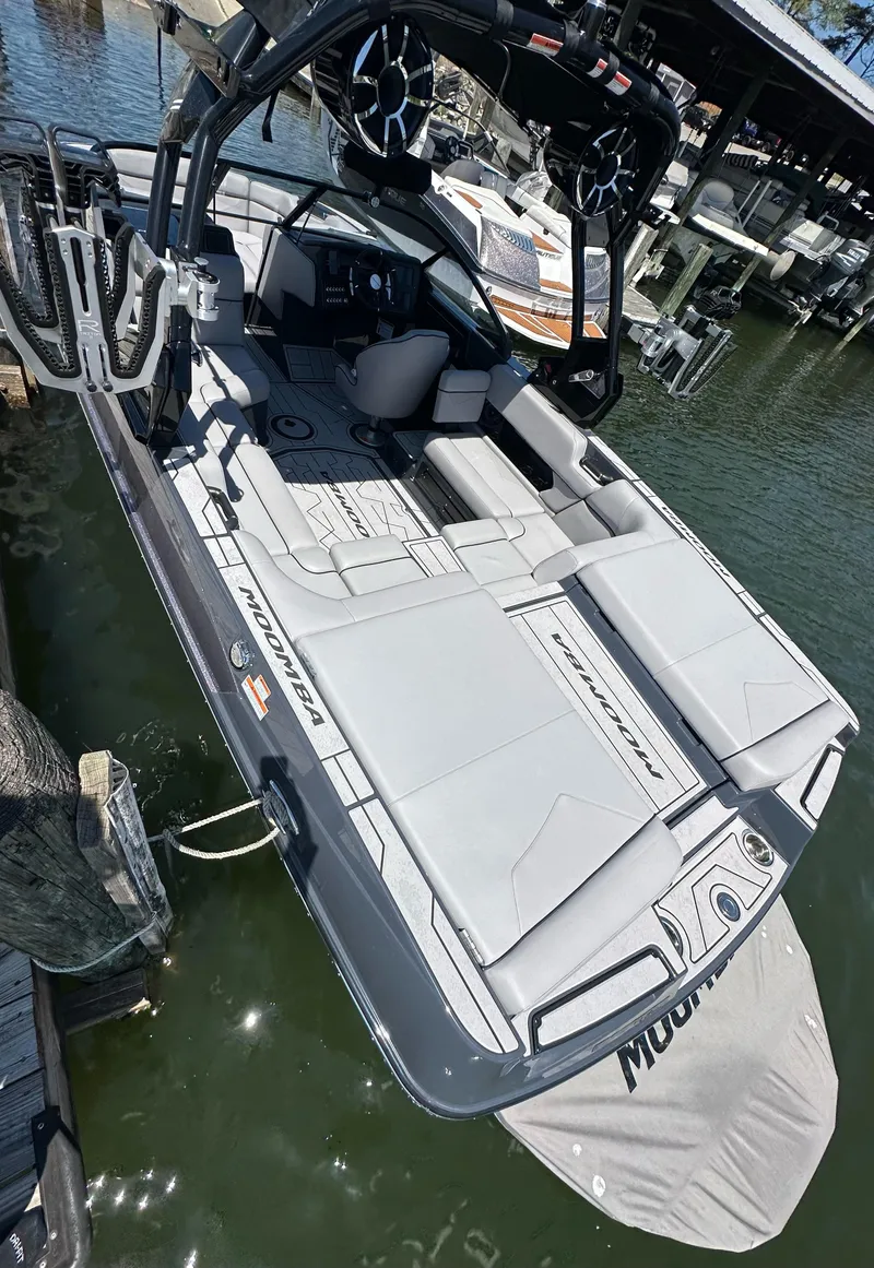 Slide: The Image of 2024 Moomba Kaiyen boat docked, featuring sleek design and spacious seating. - 5