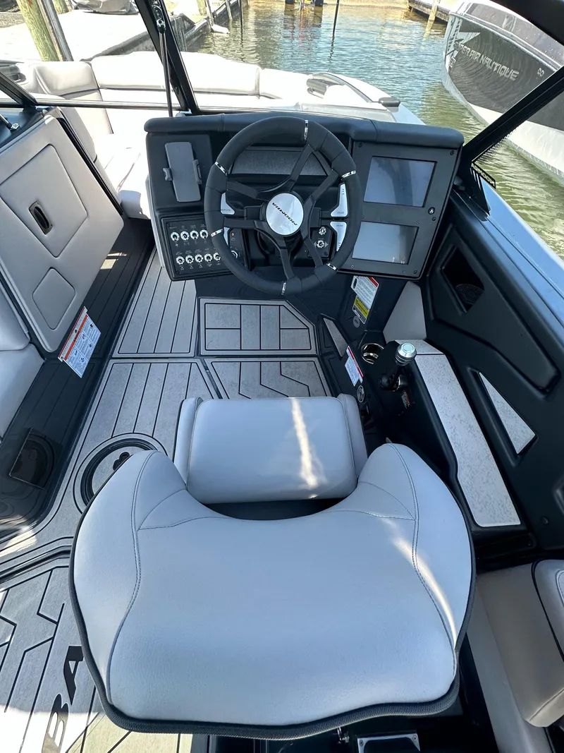 Slide: The Image of 2024 Moomba Kaiyen boat interior with steering wheel and modern dashboard. - 8