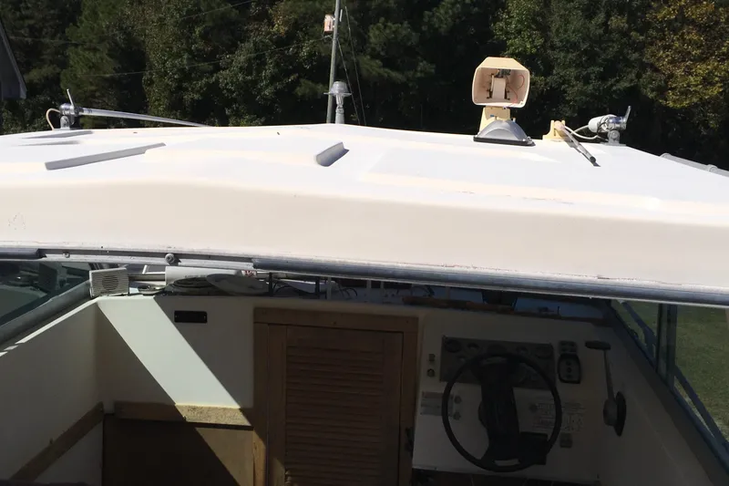 Slide: The Image of 1976 Sport-Craft 25 boat cockpit with steering wheel and control panel. - 14