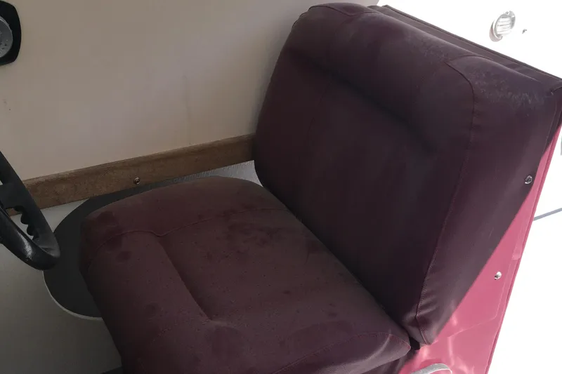 Slide: The Image of Maroon seat in 1976 Sport-Craft 25 boat interior, near steering wheel. - 19