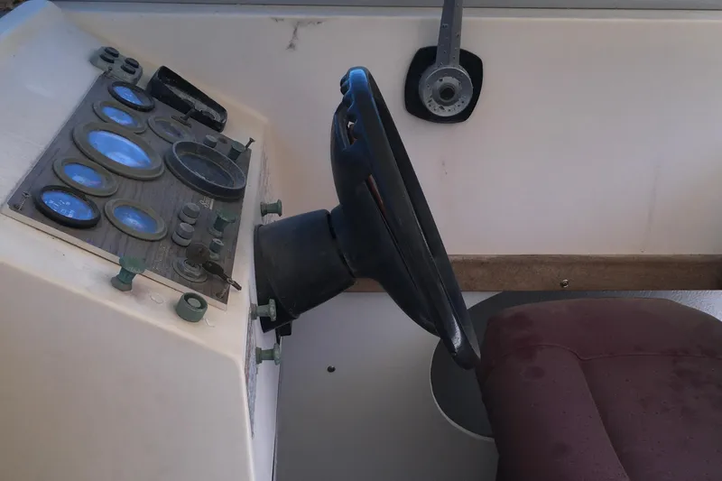 Slide: The Image of 1976 Sport-Craft 25 boat dashboard with steering wheel and gauges. - 20