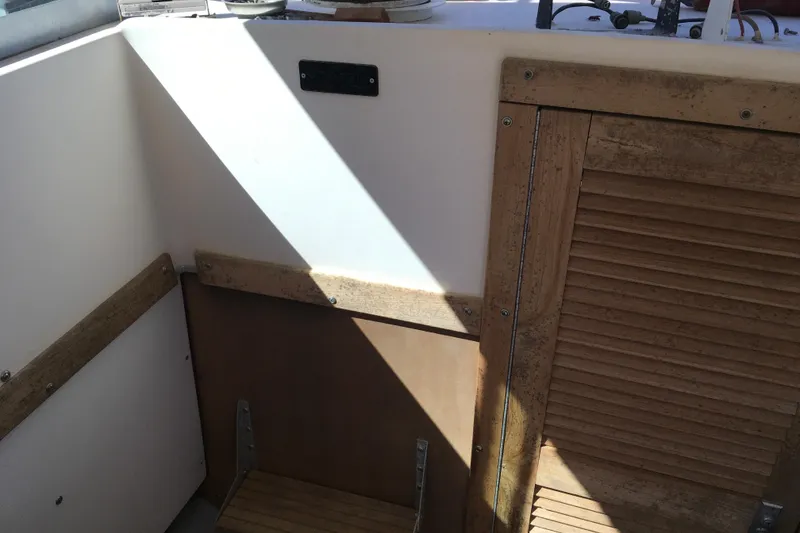 Slide: The Image of 1976 Sport-Craft 25 boat interior with wooden paneling and sunlight. - 24