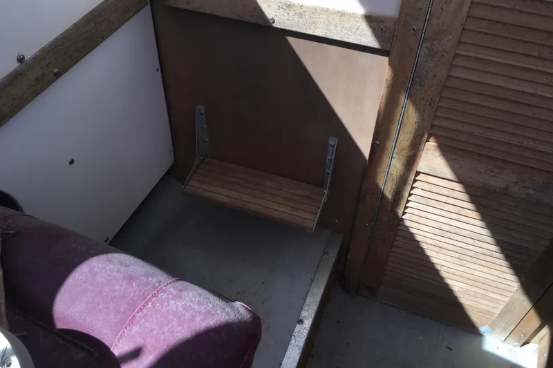 Slide: The Image of Interior of a 1976 Sport-Craft 25 boat with wooden and metal details. - 25