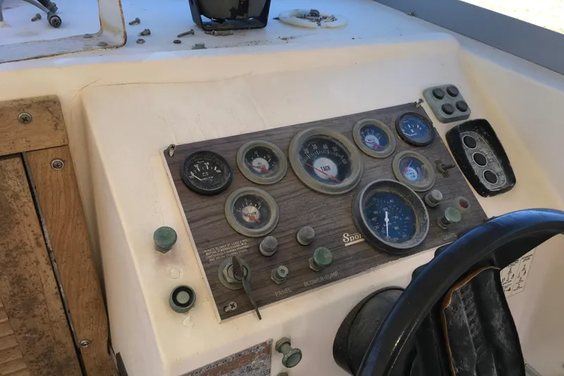 Slide: The Image of 1976 Sport-Craft 25 boat dashboard with gauges and controls, featuring a vintage design. - 27