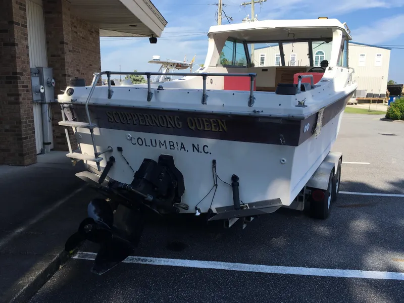 Slide: The Image of 1976 Sport-Craft 25 boat named "Scuppernong Queen" in Columbia, NC parking lot. - 4