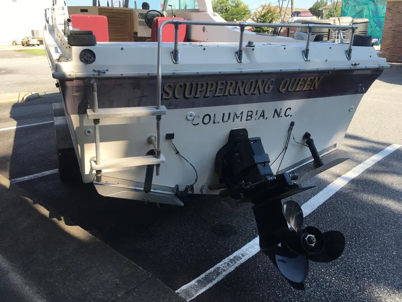 Slide: The Image of 1976 Sport-Craft 25 boat named "Scuppernong Queen" in Columbia, N.C., parked in a lot. - 5
