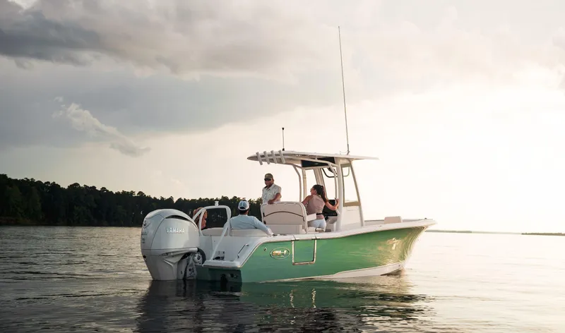 The Image of 2024 Sea Hunt Ultra 239 SE boat on calm water at sunset. - 0