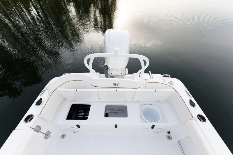 Slide: The Image of 2024 Sea Hunt Ultra 239 SE boat stern view on calm water. - 11