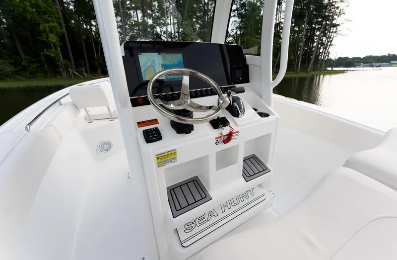 Slide: The Image of 2024 Sea Hunt Ultra 239 SE boat console with steering wheel and navigation system. - 16