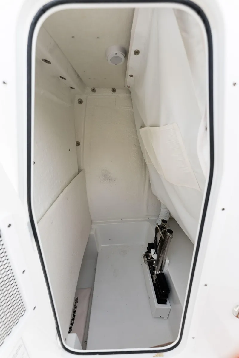 Slide: The Image of 2024 Sea Hunt Ultra 239 SE storage compartment interior. - 18