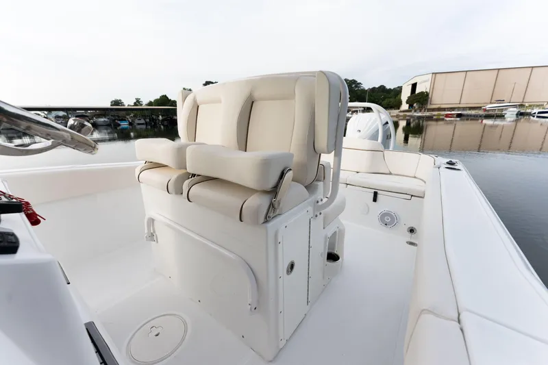Slide: The Image of 2024 Sea Hunt Ultra 239 SE boat interior with dual captain's chairs. - 20