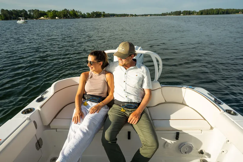 Slide: The Image of Couple relaxing on a 2024 Sea Hunt Ultra 239 SE boat on a sunny day. - 5