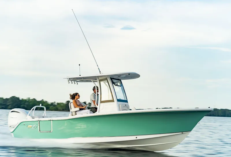 Slide: The Image of 2024 Sea Hunt Ultra 239 SE boat cruising on a calm lake. - 7