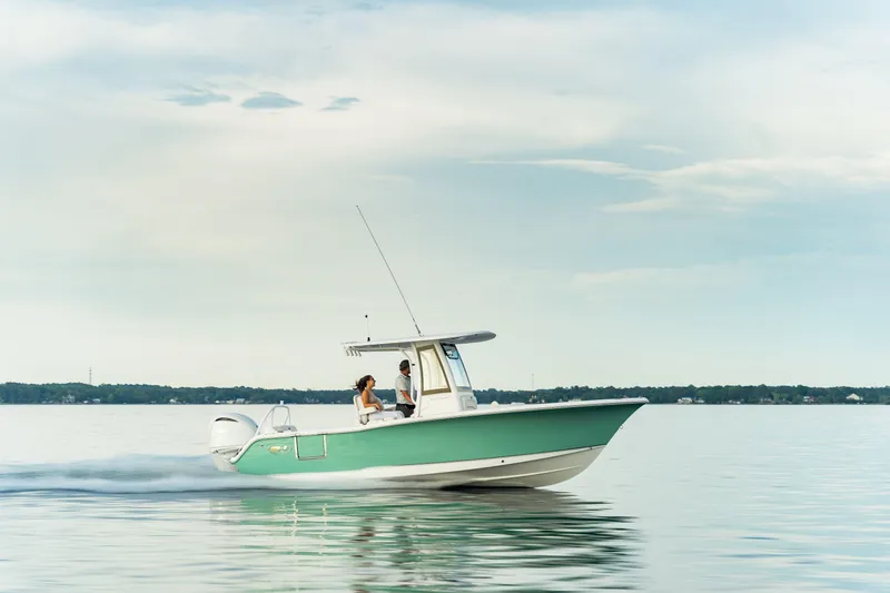 Slide: The Image of 2024 Sea Hunt Ultra 239 SE boat cruising on calm water. - 8