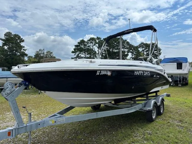 The Image of 2022 Hurricane SS 205 OB boat on trailer, named "Happy Days," under a partly cloudy sky. - 1