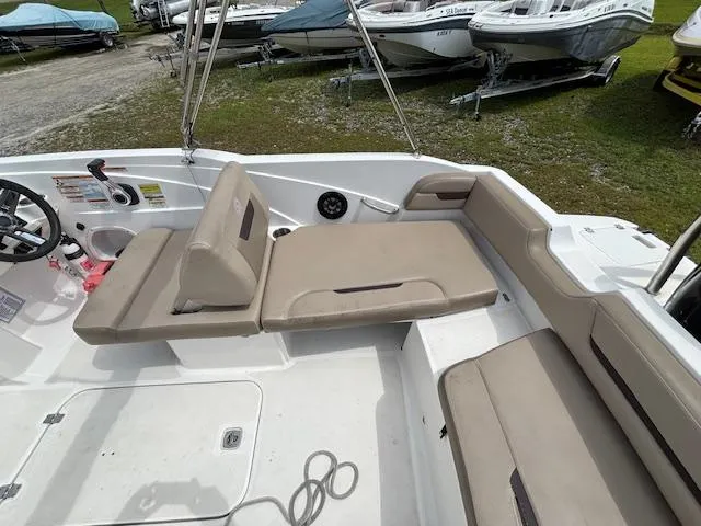 Slide: The Image of 2022 Hurricane SS 205 OB boat interior with beige seating and steering wheel. - 10