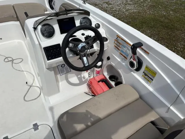 Slide: The Image of 2022 Hurricane SS 205 OB boat cockpit with steering wheel, gauges, and seating. - 12