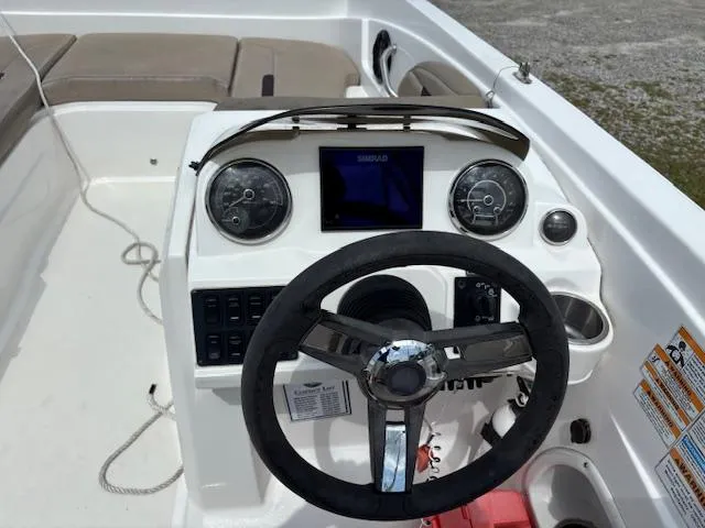 Slide: The Image of 2022 Hurricane SS 205 OB boat dashboard with steering wheel and control panel. - 16