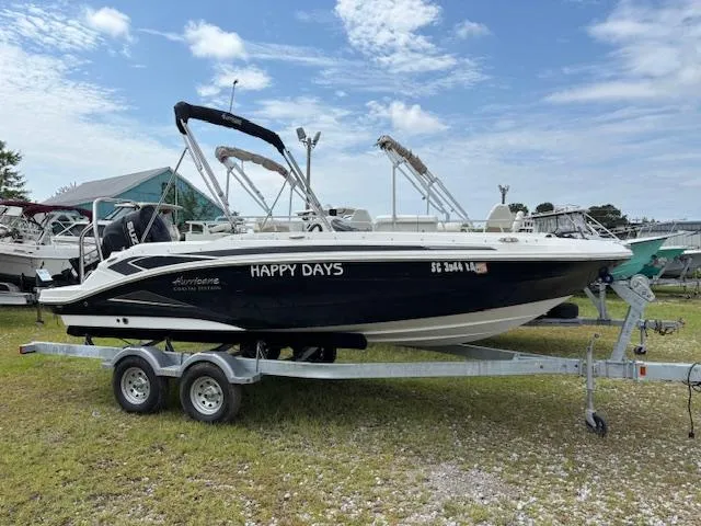 Slide: The Image of 2022 Hurricane SS 205 OB boat named "Happy Days" on a trailer, parked outdoors. - 3