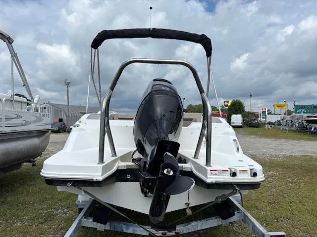 Slide: The Image of 2022 Hurricane SS 205 OB boat, rear view with outboard motor, parked outdoors. - 5