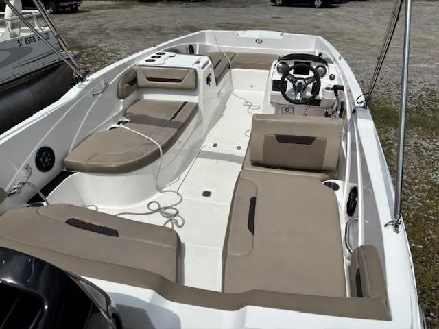 Slide: The Image of 2022 Hurricane SS 205 OB boat interior with beige seating and steering console. - 7